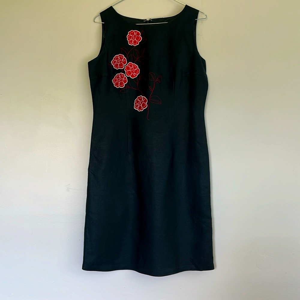 Lovely black dress with appliqué design. Ramie/rayon shell with lining. Size 6.